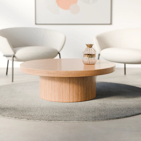 שולחן סלון עגול Syngo עם פלטת פורניר טבעי ובסיס גלילי רחב בעיצוב מינימליסטי